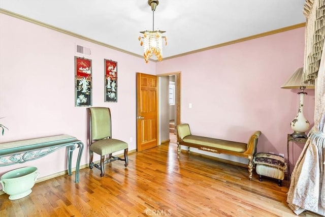 17861 Cathedral Pl, Encino, CA 91316 - living area featuring a chandelier, ornamental molding, and wood finished floors