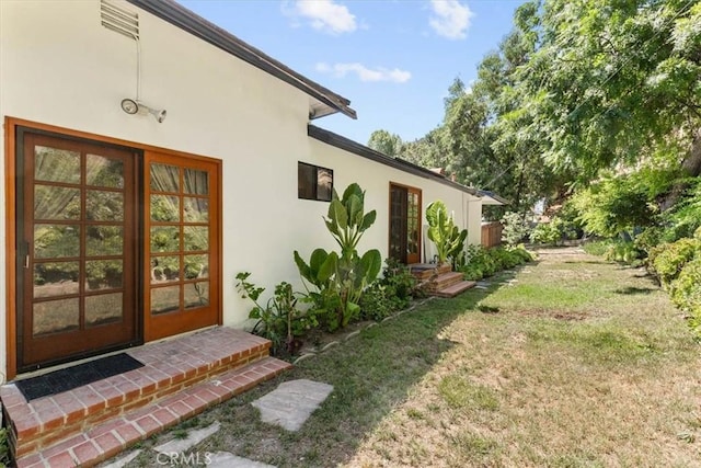 17861 Cathedral Pl, Encino, CA 91316 - property entrance with stucco siding and a lawn