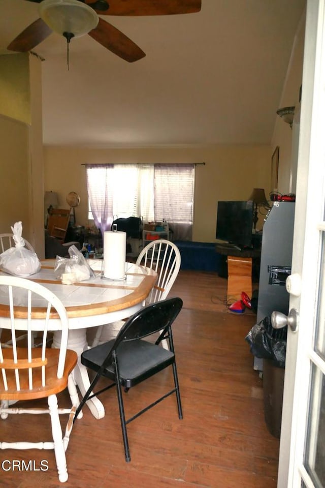 dining room featuring a ceiling fan and wood finished floors