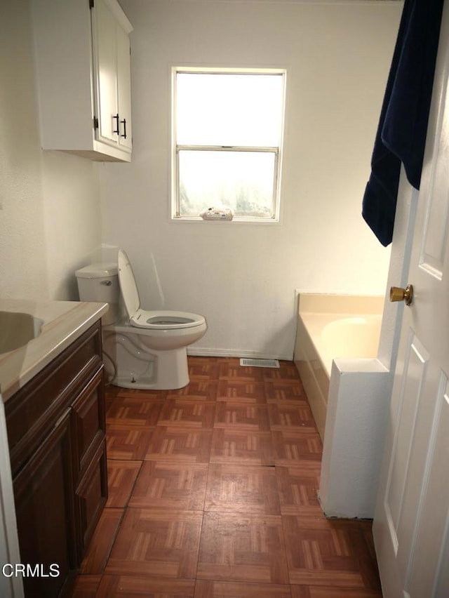full bath with a bath, toilet, and vanity