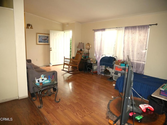 interior space with crown molding and wood finished floors