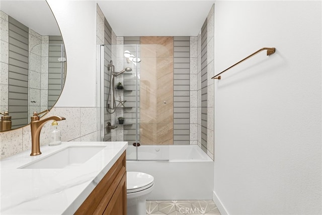 full bathroom featuring toilet, tub / shower combination, tile walls, tile patterned flooring, and vanity