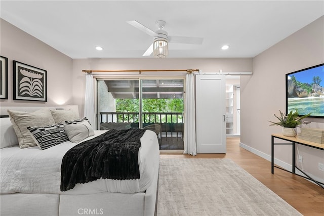 bedroom with baseboards, wood finished floors, recessed lighting, and access to exterior