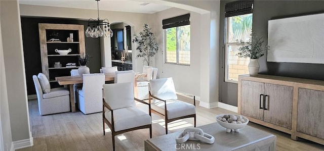 29310 Paseo Palmar, San Juan Capistrano, CA 92675 - dining room with arched walkways, light wood-style flooring, a chandelier, and baseboards