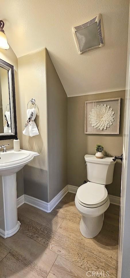 29310 Paseo Palmar, San Juan Capistrano, CA 92675 - bathroom with lofted ceiling, toilet, and baseboards