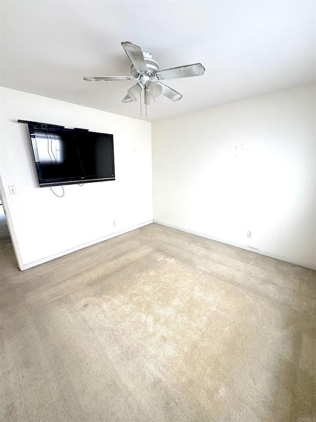 unfurnished room featuring ceiling fan, carpet, and baseboards