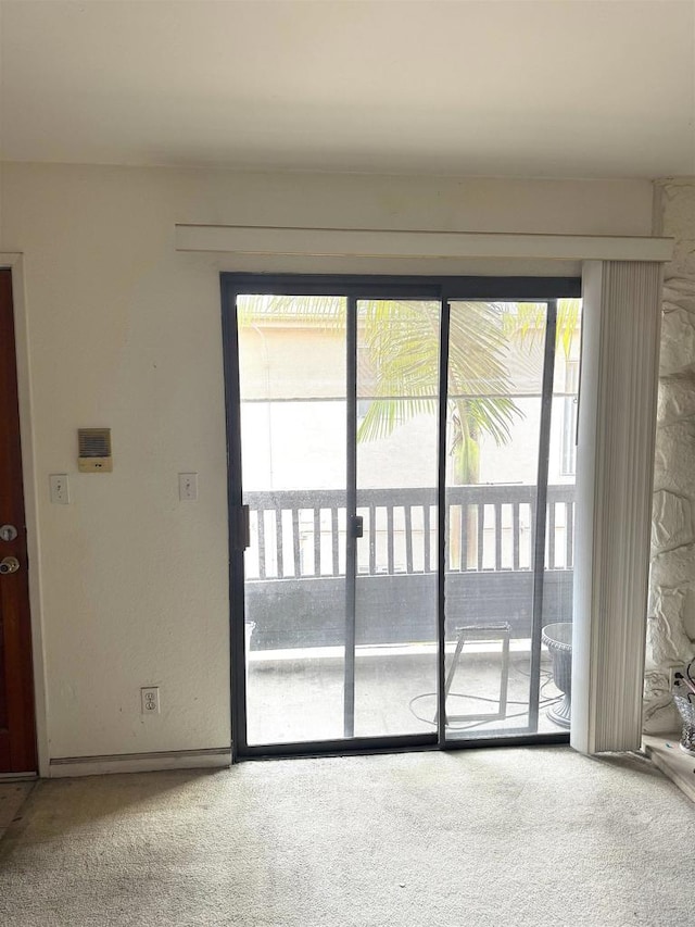 doorway with carpet flooring and healthy amount of natural light