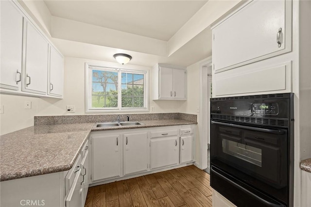 3540 S Flemington Dr, West Covina, CA 91792 - kitchen featuring oven, a sink, white cabinetry, a warming drawer, and dark wood-style flooring