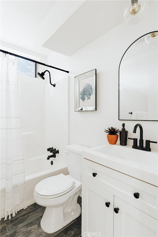 bathroom with vanity, toilet, shower / bathtub combination with curtain, and wood finished floors