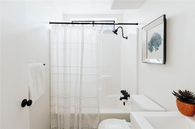 full bath with toilet and shower / bath combo with shower curtain