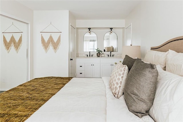 bedroom featuring a sink and ensuite bath