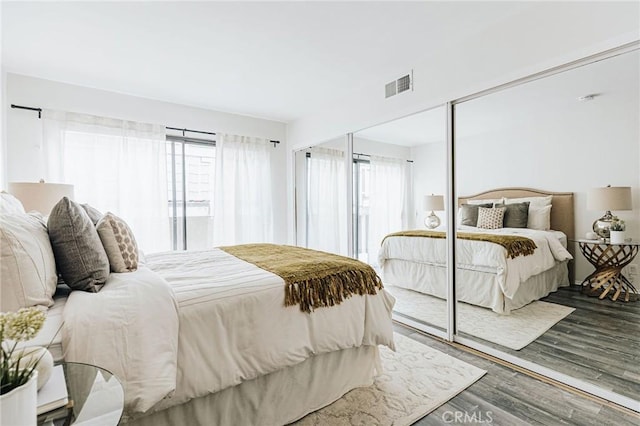 bedroom with visible vents and wood finished floors