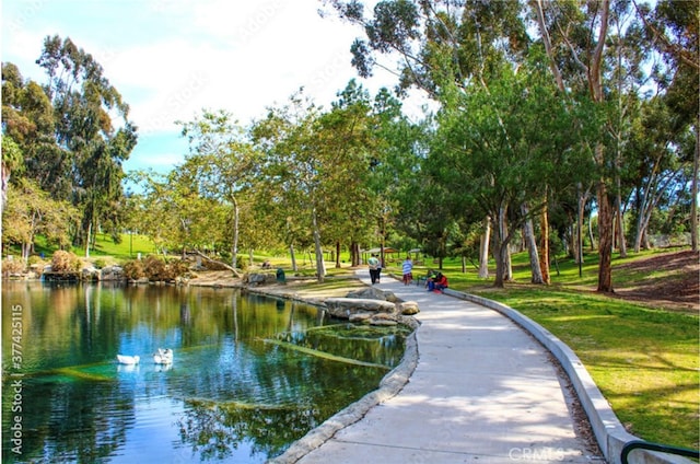 view of home's community with a yard and a water view