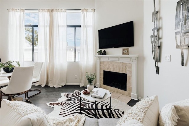 living room featuring a fireplace and baseboards