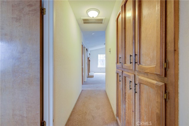 corridor featuring light carpet and visible vents
