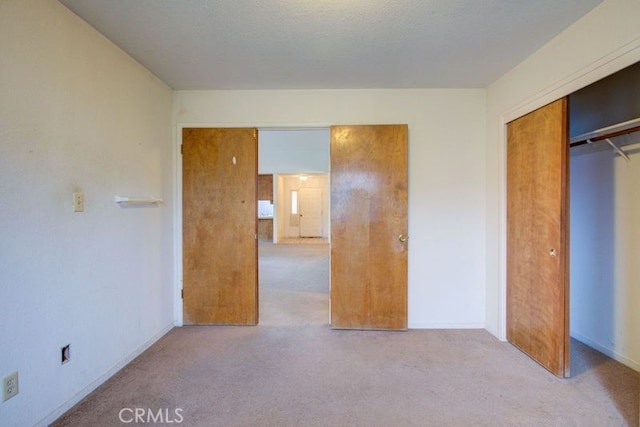 unfurnished bedroom featuring baseboards, a closet, and carpet floors