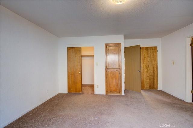 unfurnished bedroom featuring carpet flooring and baseboards