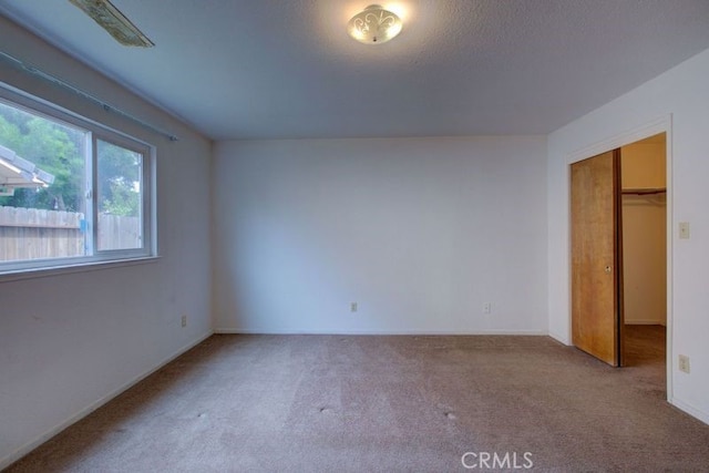 unfurnished bedroom with carpet flooring and a closet