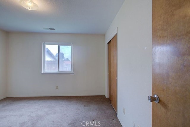 carpeted spare room with visible vents
