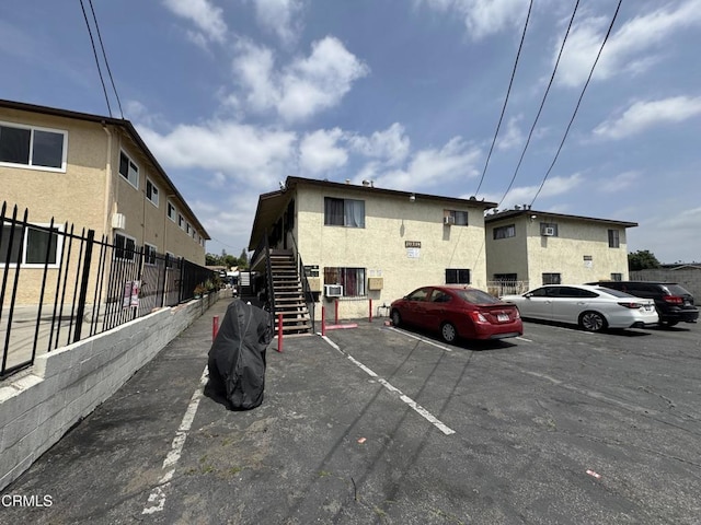uncovered parking lot with stairs and fence