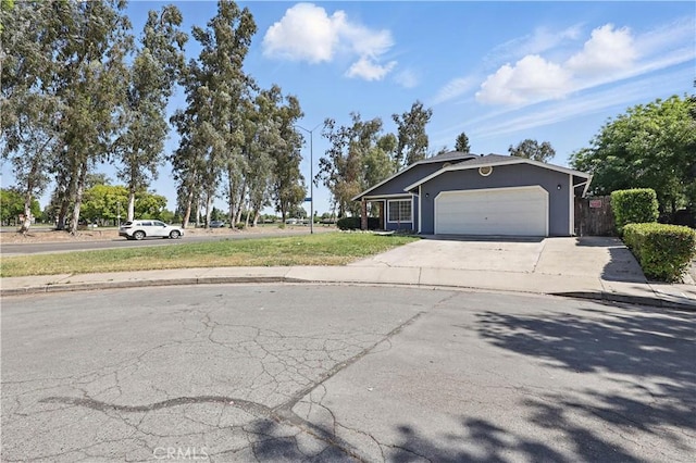 624 Rensselaer Ct, Merced, CA 95348 - view of front of home featuring stucco siding, driveway, fence, and a garage