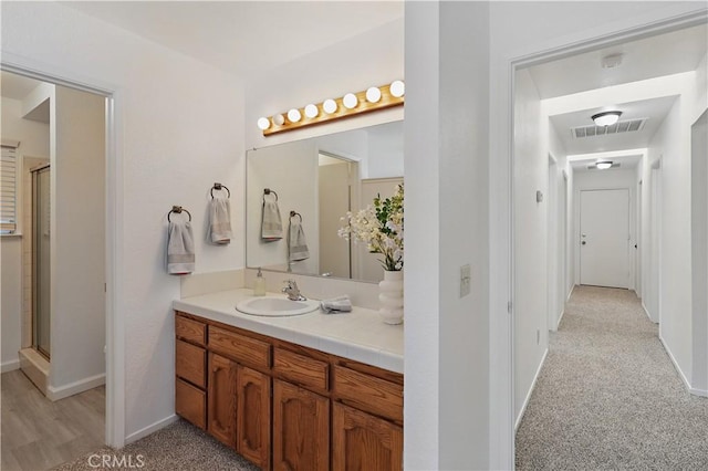624 Rensselaer Ct, Merced, CA 95348 - full bathroom with baseboards, a shower with door, vanity, and visible vents