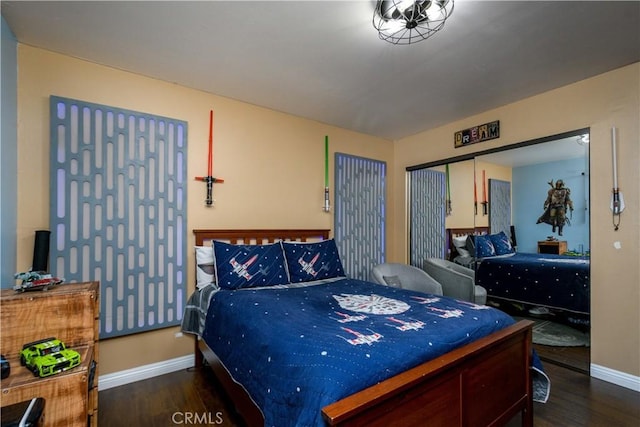 bedroom featuring baseboards and wood finished floors