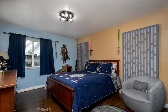 bedroom featuring wood finished floors and baseboards