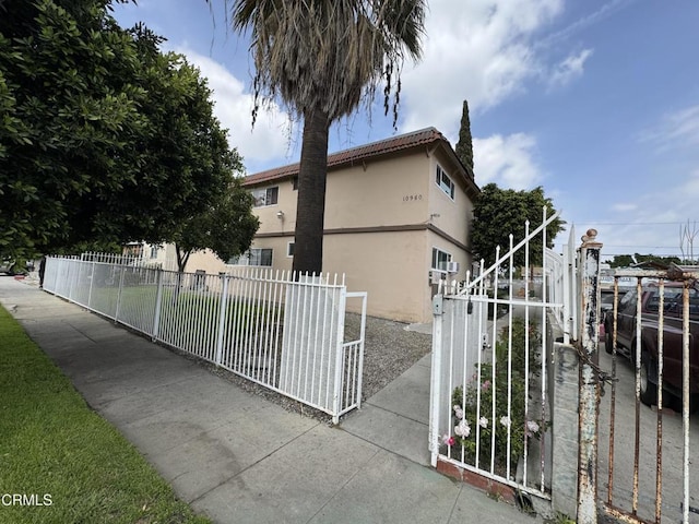 view of property exterior featuring stucco siding and fence