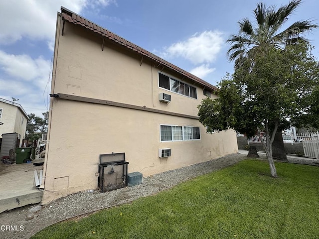 view of home's exterior with a yard and stucco siding