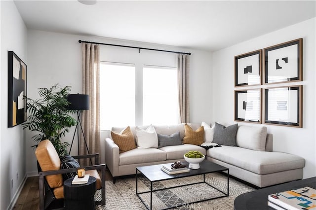 living room featuring plenty of natural light, wood finished floors, and baseboards