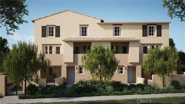 view of front of home with stucco siding and fence