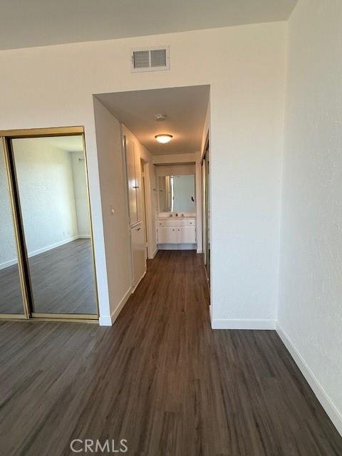 321 S San Vicente Blvd S Unit 402, Los Angeles, CA 90048 - hall with baseboards, visible vents, and dark wood-type flooring