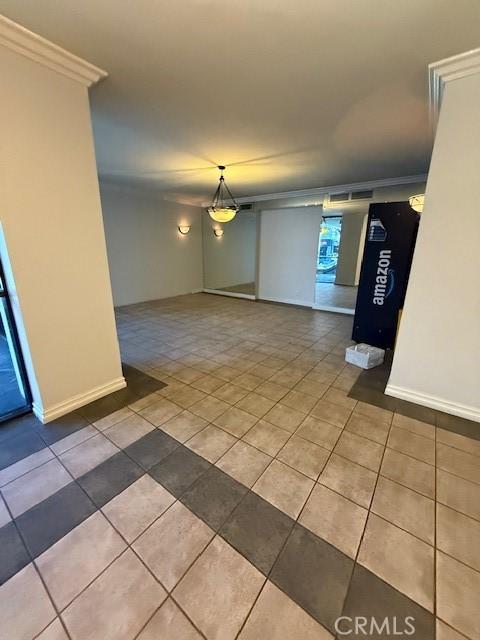 321 S San Vicente Blvd S Unit 402, Los Angeles, CA 90048 - tiled empty room featuring baseboards and crown molding