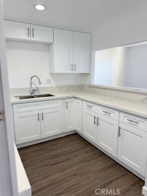 321 S San Vicente Blvd S Unit 402, Los Angeles, CA 90048 - kitchen with light stone countertops, recessed lighting, dark wood finished floors, a sink, and white cabinets