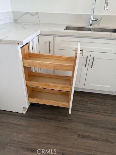 321 S San Vicente Blvd S Unit 402, Los Angeles, CA 90048 - details with light countertops, dark wood finished floors, white cabinets, and a sink