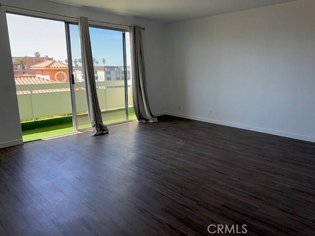 321 S San Vicente Blvd S Unit 402, Los Angeles, CA 90048 - spare room featuring baseboards and dark wood finished floors