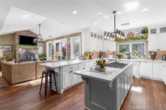 1405 Rock Ridge Dr, Lake Arrowhead, CA 92352 - kitchen with open floor plan, a chandelier, visible vents, and a breakfast bar