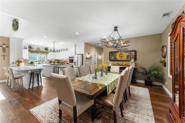 1405 Rock Ridge Dr, Lake Arrowhead, CA 92352 - dining room featuring an inviting chandelier, baseboards, dark wood-type flooring, and visible vents