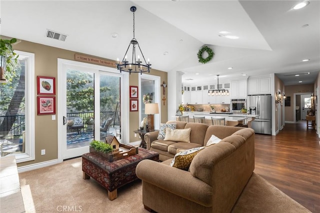 1405 Rock Ridge Dr, Lake Arrowhead, CA 92352 - living area with lofted ceiling, visible vents, a chandelier, dark wood-style flooring, and baseboards