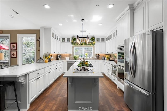1405 Rock Ridge Dr, Lake Arrowhead, CA 92352 - kitchen featuring a peninsula, appliances with stainless steel finishes, plenty of natural light, and white cabinets