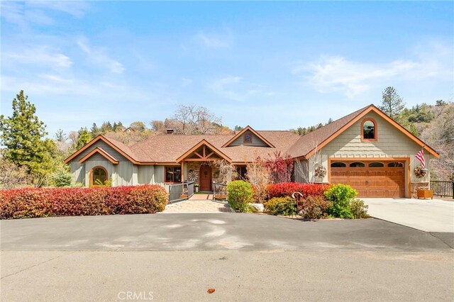 1405 Rock Ridge Dr, Lake Arrowhead, CA 92352 - ranch-style home with stone siding, driveway, and a garage