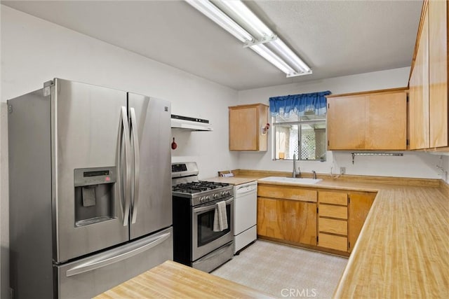 568 4th St, Willows, CA 95988 - kitchen with a sink, under cabinet range hood, light countertops, and appliances with stainless steel finishes