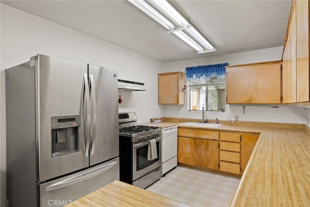 568 4th St, Willows, CA 95988 - kitchen with appliances with stainless steel finishes, under cabinet range hood, light countertops, and light flooring