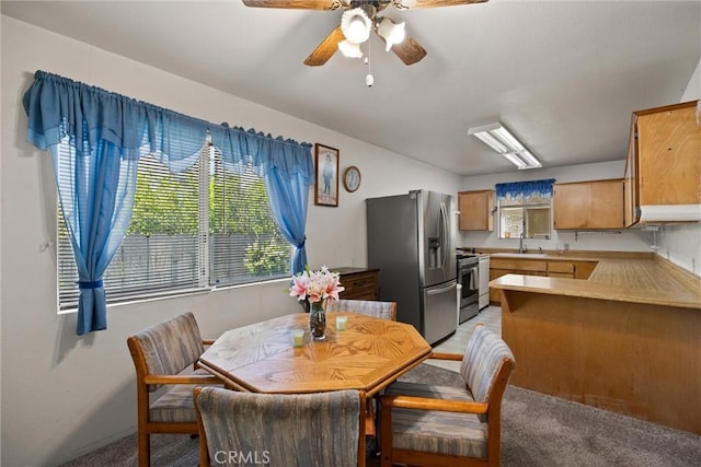 568 4th St, Willows, CA 95988 - dining room with light colored carpet, a ceiling fan, and baseboards