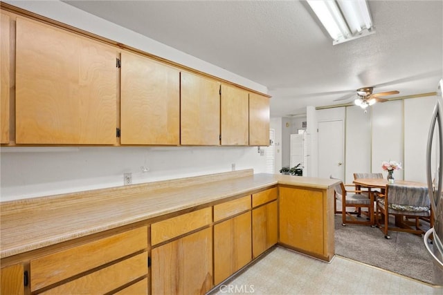568 4th St, Willows, CA 95988 - kitchen featuring a peninsula, light floors, a textured ceiling, light countertops, and a ceiling fan