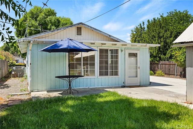 view of outbuilding with fence