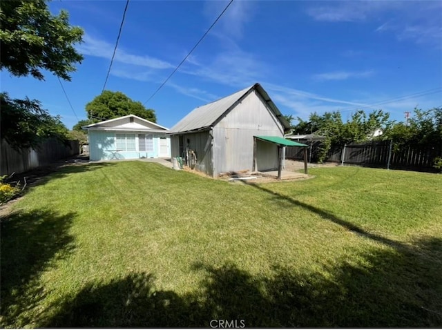 568 4th St, Willows, CA 95988 - rear view of house with a fenced backyard and an outdoor structure