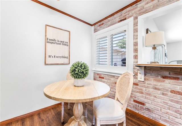 12172 Manley St, Garden Grove, CA 92845 - dining area with baseboards, ornamental molding, wood finished floors, and brick wall