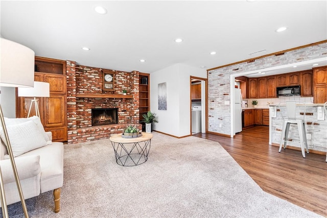 12172 Manley St, Garden Grove, CA 92845 - living room with washer / clothes dryer, a fireplace, recessed lighting, baseboards, and light wood-style floors